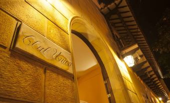 "a nighttime scene of a yellow building with a sign that reads "" cafe rio "" prominently displayed on the front door" at Hotel Union