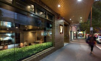 a brick building with a large glass window , allowing natural light to fill the interior at 57Hotel