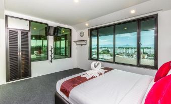 a hotel room with a king - sized bed , a flat - screen tv mounted on the wall , and a view of the ocean at Soho Boutique Hotel