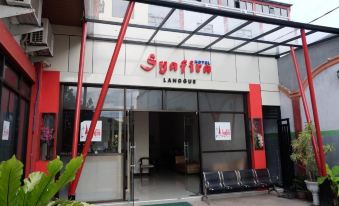 "a modern building with a red and white sign that reads "" lan du . asia "" prominently displayed" at Syafira Hotel Langgur