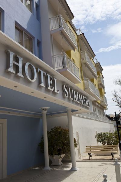 "a building with the words "" hotel summer "" written on it , located in a city setting" at Hotel Summery