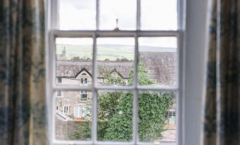 a view of a town from inside a white window with two yellow bars on either side at Snooty Fox