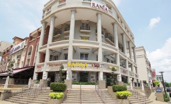 "a large building with a sign that reads "" rania "" prominently displayed on the front of the building" at Monaco Hotel