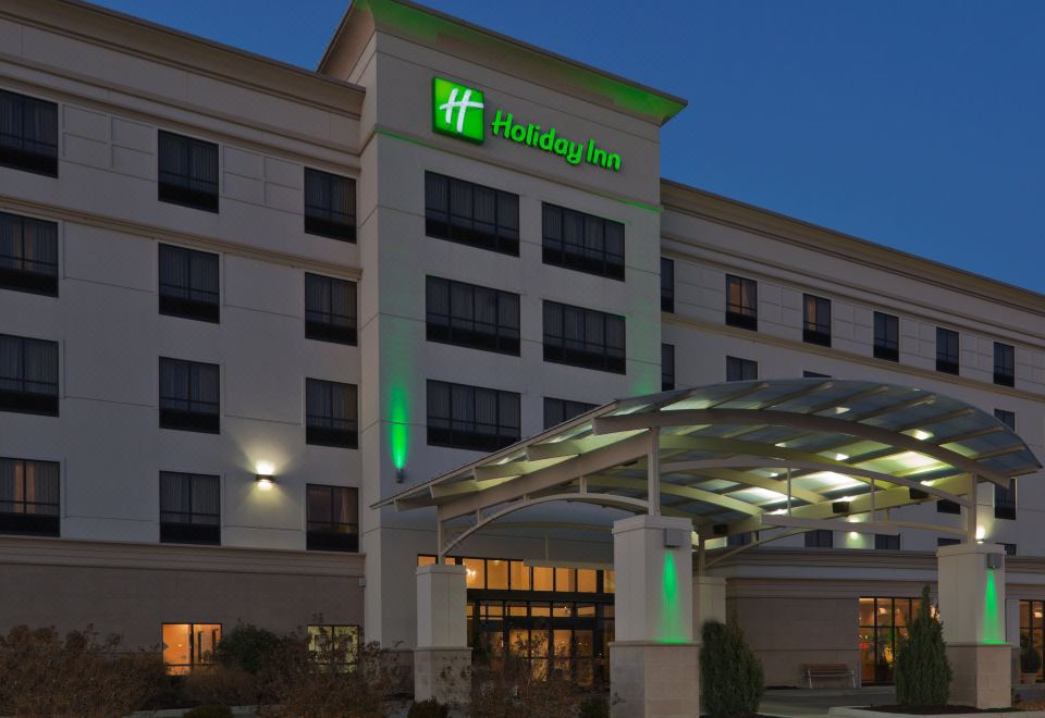 "a large hotel with a green sign that says "" holiday inn "" on the front of the building" at Holiday Inn Carbondale-Conference Center