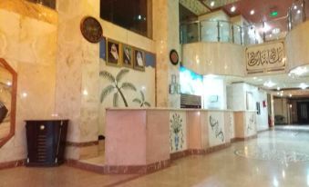 In front of the lobby, there are two tables and chairs, and next to them is an empty room at Jouhara Mouassar Hotel