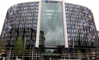 "a modern building with a large glass window and the words "" all roads lead to paris "" on it" at Park Plaza Westminster Bridge London