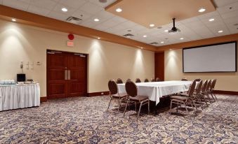 a conference room set up for a meeting , with tables and chairs arranged in a semicircle at Best Western Plus Barclay Hotel