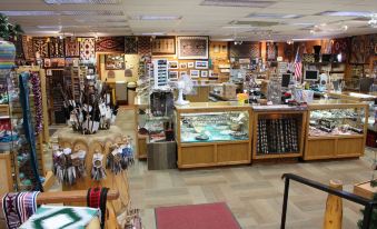 a store filled with various items for sale , including clocks , spoons , and other kitchenware at Goulding's Lodge