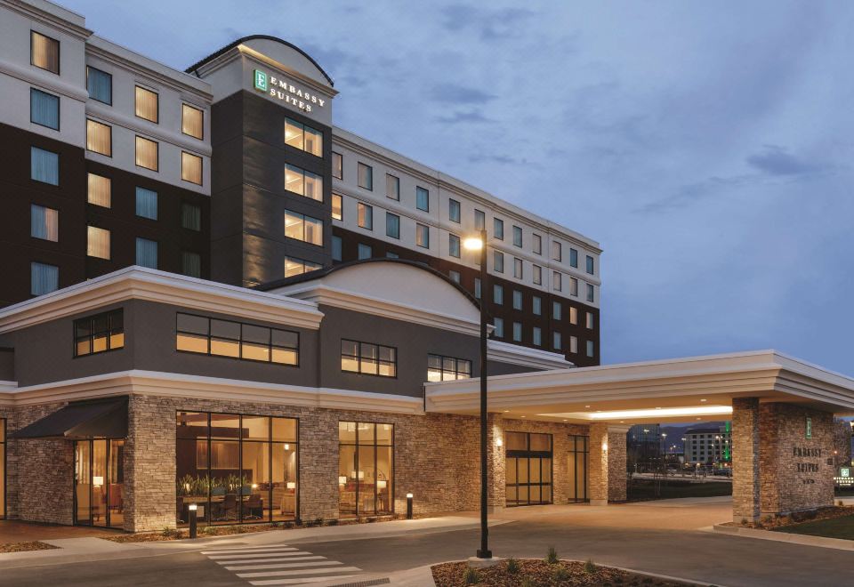 "a large hotel building with a sign that says "" hampton inn "" on the front of the building" at Embassy Suites by Hilton South Jordan Salt Lake City