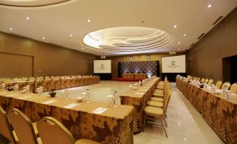 a large conference room with multiple long tables and chairs arranged for a meeting or event at The Singhasari Resort Batu