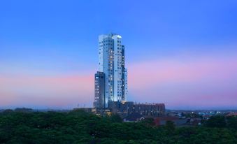 a tall building with a blue sky in the background and trees in the foreground at Alila Solo