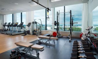 a well - equipped gym with a variety of exercise equipment , including weight machines , treadmills , and benches at Gothia Towers & Upper House