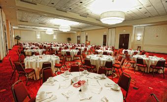 a large banquet hall filled with round tables and chairs , ready for a formal event at Mobile Marriott