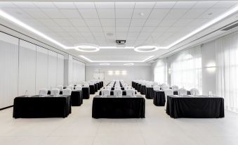 a large conference room with rows of chairs arranged in a semicircle , ready for a meeting at Oliva Nova Beach & Golf Hotel