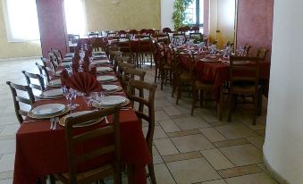 a large dining room filled with tables and chairs , ready for guests to sit and enjoy a meal at Hotel Millennium