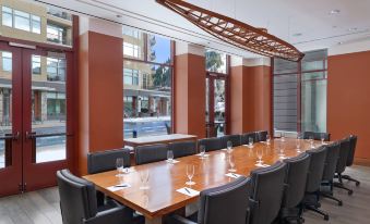 a large conference room with a long wooden table , chairs , and wine glasses arranged for a meeting at The Westin Riverfront Resort & Spa, Avon, Vail Valley