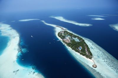 a bird 's eye view of a tropical island with clear blue water and green vegetation at Vilamendhoo Island Resort & Spa