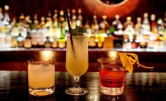 a bar counter with three different types of cocktails , including a mojito and an other drinks at White Horse Inn