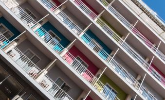 a multi - story building with colorful balconies and windows , giving it a modern and stylish appearance at Artiem Capri