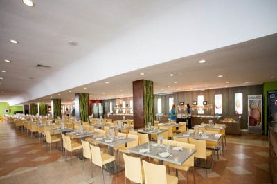 a large , empty banquet hall with multiple tables and chairs set up for a formal event at Club Mac Club Mac - All Inclusive Family Resort Photo