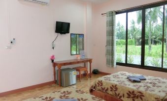 a modern hotel room with two beds , a desk , and a window , decorated with floral patterns at S P Resort