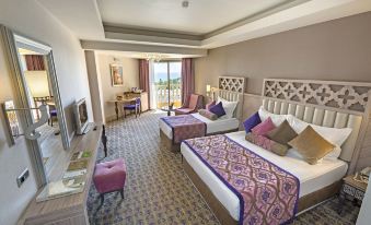 a hotel room with two beds , a couch , and a dining table , all decorated in a traditional style at Royal Alhambra Palace