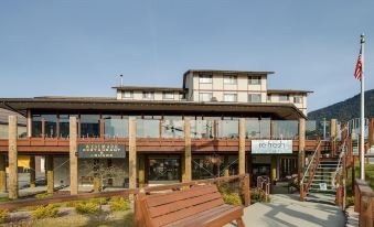 "a large wooden building with a sign that reads "" pearl hotel "" and a bench in front of it" at Westmark Sitka