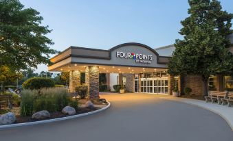 the exterior of a four points by sheraton hotel with a large sign above the entrance at Four Points by Sheraton Chicago O'Hare