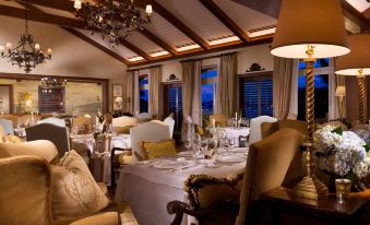 a well - decorated dining room with multiple tables and chairs , creating a warm and inviting atmosphere at Rosewood Bermuda