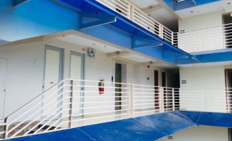 The apartment building has a balcony with blue and white tiled floors, offering a scenic view at FLOR- AL MANSION