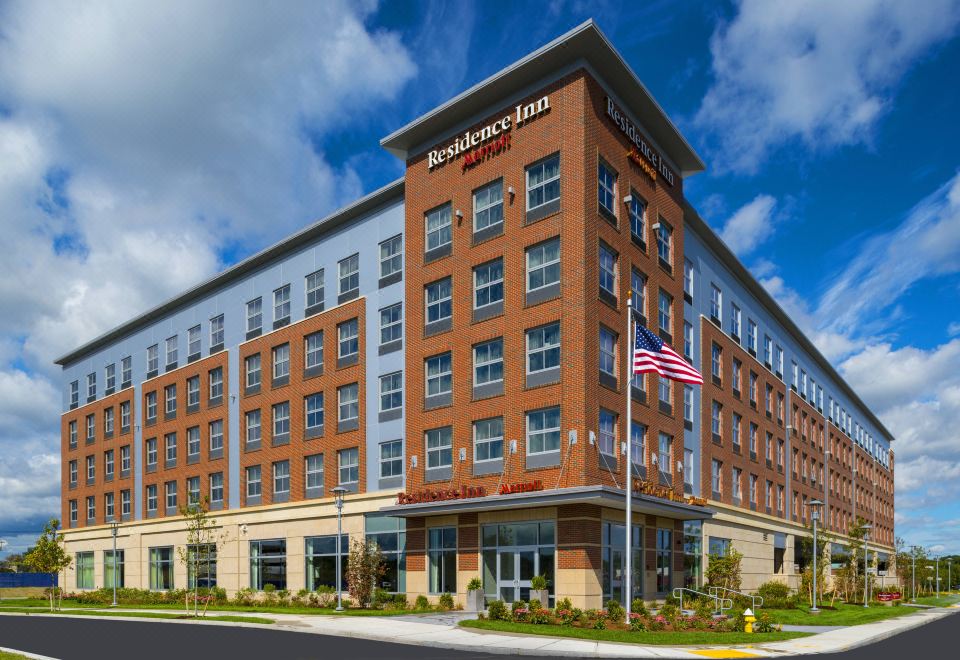 "a modern hotel building with multiple floors and windows , featuring the name "" residence inn by marriott "" above the entrance" at Residence Inn by Marriott Boston Needham