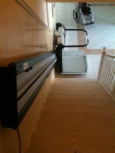 a staircase with a ladder leaning against the wall , and a washing machine in the background at Hotel Summery