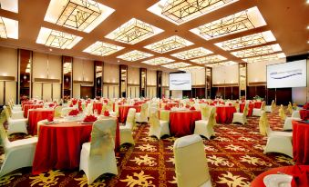 a large banquet hall with multiple tables and chairs set up for a formal event at ASTON Purwokerto Hotel & Convention Center