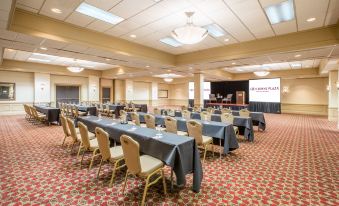 a large conference room with rows of tables and chairs set up for a meeting or event at Crowne Plaza Cleveland Airport