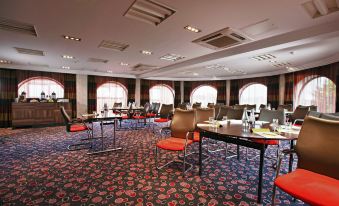 a large conference room with multiple tables and chairs arranged for a meeting or event at Leonardo Hotel and Conference Venue Hinckley Island