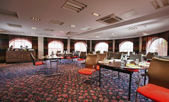 a large conference room with multiple chairs arranged in rows and a table in the center at Leonardo Hotel and Conference Venue Hinckley Island