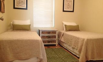 a room with two twin beds , one on the left and one on the right side of the room at Mountain Cove Farms Resort