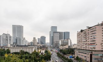 A city with tall buildings on both sides, including the skyline in front at Howdy Smart Hotel (Chengdu Chunxi Taikoo Li)