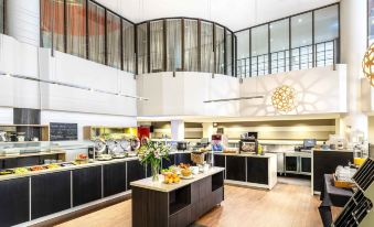 a large dining room with a buffet table filled with a variety of food items at Ibis Melbourne Hotel and Apartments