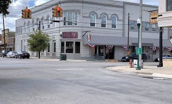 a street corner with a building on the left side and a car parked in front of it at The Dilworth Inn