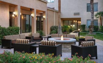 a courtyard with several chairs and a fire pit , creating a cozy outdoor living space at Courtyard by Marriott Las Vegas Convention Center