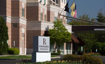 "a large hotel with a sign that reads "" renaissance renaissance place "" in front of it" at Renaissance Meadowlands Hotel