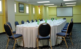 a large conference room with a long table and numerous chairs arranged for a meeting at Wyndham Reef Resort Grand Cayman