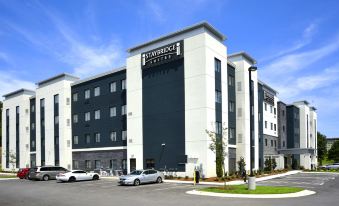"a modern hotel building with the words "" fairfield inn & suites "" prominently displayed on its side" at Eastwood Hall