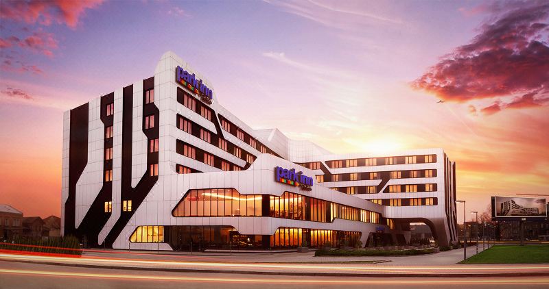 "a large , modern hotel building with the words "" best western "" prominently displayed on its side" at Park Inn by Radisson Krakow