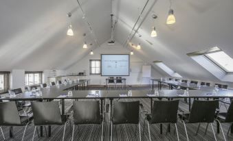 a large conference room with rows of chairs arranged in a semicircle around a long table at Fletcher Hotel - Restaurant Nautisch Kwartier