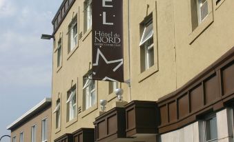 "a hotel building with a sign that reads "" hotel mks "" prominently displayed on the front of the building" at Hotel du Nord