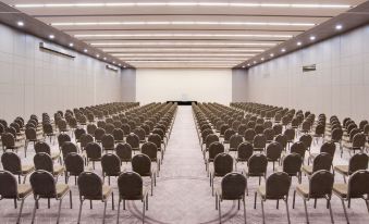 a large conference room with rows of chairs arranged in a semicircle , and a projector screen mounted on the wall at Sheraton Dubrovnik Riviera Hotel