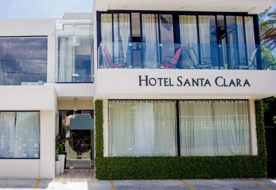 "a large white building with a sign that reads "" hotel santa clara "" prominently displayed on the front" at Hotel Santa Clara