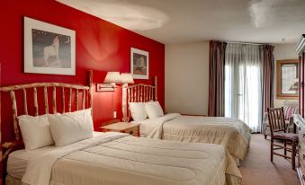 a hotel room with two beds , one on the left side and the other on the right side of the room at Quartz Mountain Resort